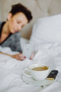 Kaboompics - Woman taking photo of coffee in bed
