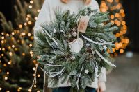 Kaboompics - The woman is holding a Christmas wreath in her hands