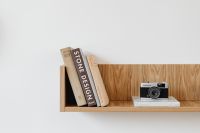 Kaboompics - Old analog camera on wooden shelf - books