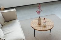 Wooden coffee table - rug - living room - candle - vase - linen couch - pillows