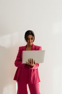 Elegant Asian Businesswoman in Satin Suit Focused on Laptop Work\ ![Elegant Asian Businesswoman in Satin Suit Focused on Laptop Work