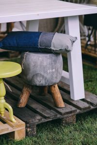 Kaboompics - Grey stool with a pillow by a table
