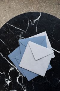 Blue & white envelopes on marble