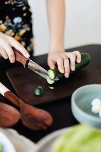 Kaboompics - Teen Girl cuts cucumber