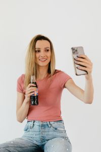 Young woman taking a salfie with iPhone 11 Pro