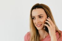 Young woman talking by mobile phone