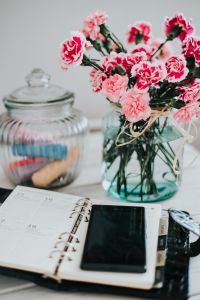 Kaboompics - Organizer, mobile phone and lovely pink flowers