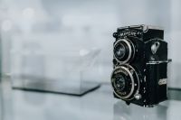 Kaboompics - Old camera on glass shelf