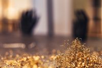 Close-ups of golden metal shavings on a table