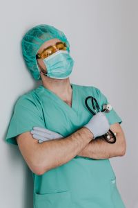Young male doctor in mask