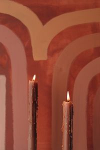 Orange-colored candles on the background of the painting