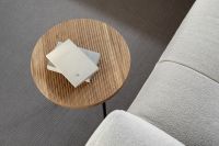 Wooden fluted table - books - light beige sofa - oak - boucle