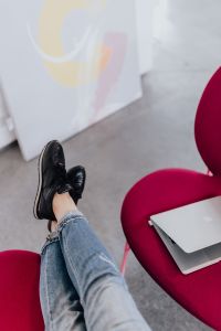 Kaboompics - Woman using laptop computer and sitting cross legs on sofa