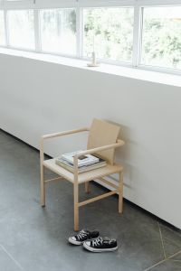 Kaboompics - Wooden minimalist chair - magazines and books - converse sneakers