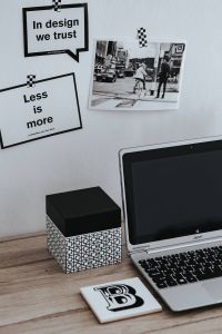 Kaboompics - Inspirational cards with quotes, a black-and-white photo and a silver laptop