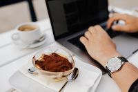 Kaboompics - A man with an elegant watch is working on a laptop. Classic tiramisu in a glass.