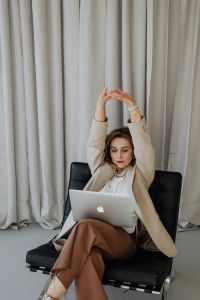 Kaboompics - Elegant businesswoman wears pearls - stretching your body - tired at work