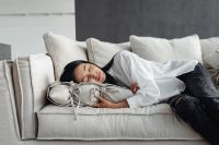 Kaboompics - Young Asian woman relaxes on couch - sleeps on pillow