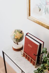 Planner on The White Marble Table, White Background, Pilea, Globe, Painting on the Wall