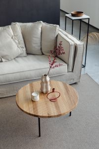 Kaboompics - Wooden coffee table - rug - living room - candle - vase - linen couch - pillows