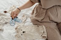 Kaboompics - Pregnant Woman Folding Clothes For Her Baby