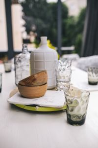 Kaboompics - Glasses and jars on a white garden table