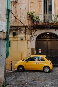 Kaboompics - Yellow modern little car, Fiat 500, parked on a street in Naples