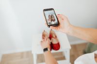 Woman takes photos of products she will sell online - red shoes