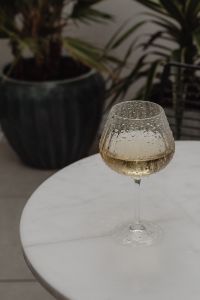 White Marble Table with a Glass of White Wine and Stylish Sunglasses - Metal Chair