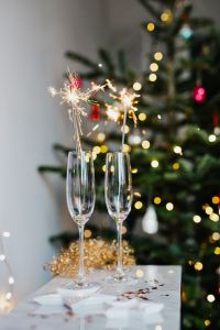 New Year's Eve - champagne glasses on a Christmas tree background