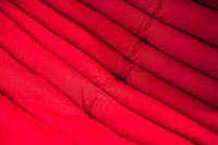 Kaboompics - Red fabrics stacked together