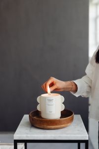 Kaboompics - A woman lights a candle