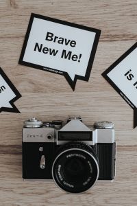 Kaboompics - Little cards with inspirational quotes and a black camera