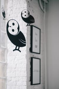 Kaboompics - Little black plastic owls hanging from a ceiling
