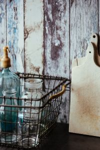 Kaboompics - Collection of bottles in metal mesh basket