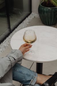 White Marble Table with a Glass of White Wine and Stylish Sunglasses - Metal Chair