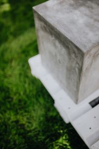 Kaboompics - Concrete side table and green grass in garden