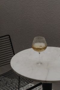 White Marble Table with a Glass of White Wine