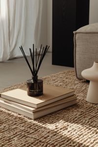Kaboompics - Jute rug - books - vase - fragrance diffuser
