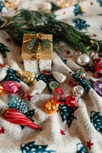 Kaboompics - Christmas gift and colourful tree decorations on a blanket