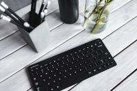 Kaboompics - Black keyboard with pencils on a white table