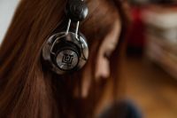 Beautiful young woman in headphones listening to music