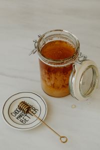 Kaboompics - Honey in a jar and a honey spoon