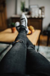 Kaboompics - Woman in ripped jeans and black sneakers