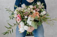 A man holds a beautiful bouquet of flowers