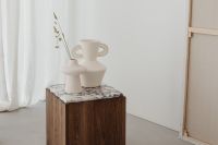 Kaboompics - Wooden side table with marble top - bright ceramic vases - concrete floor - microcement