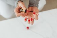 Kaboompics - Closeup of a woman painting her nails with red nail polish