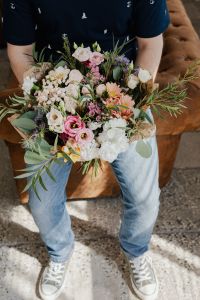 Kaboompics - A man holds a beautiful bouquet of flowers