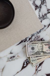 Kaboompics - Dollar bills on a marble table