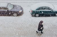 Kaboompics - Snowy Street with Cars & woman walking along a sidewalk